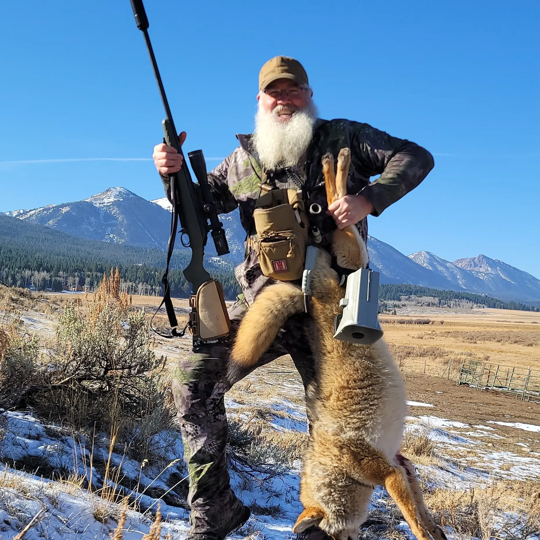 al morris posing with 4 coyotes